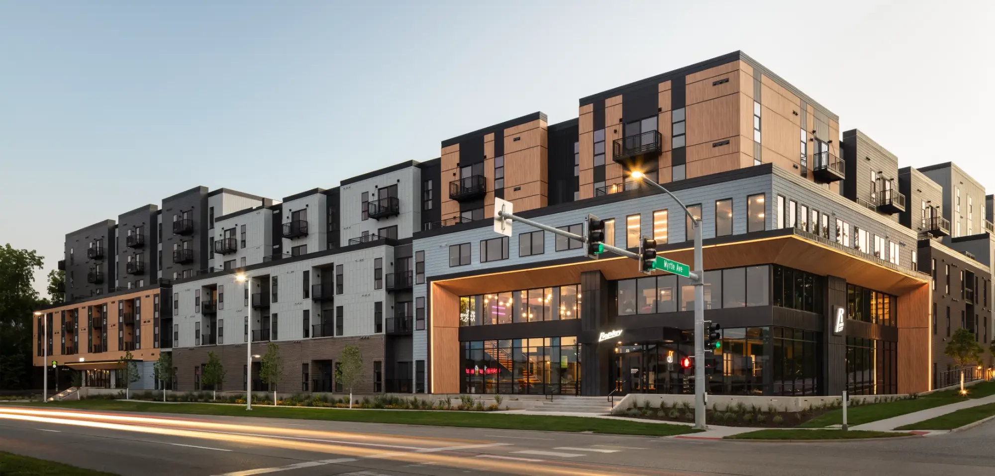 Replay Iowa City, luxury IU student apartments, exterior from across the street at sunset